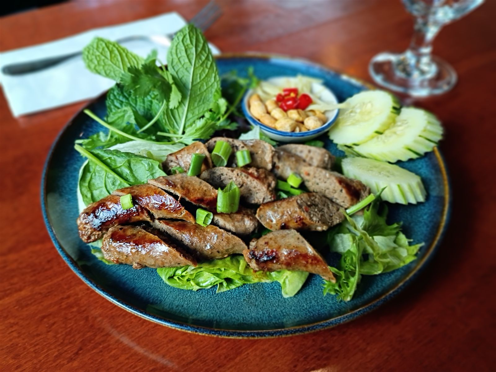 Halal spicy beef and lamb sausage appetizer served night-market style at Hanuman Thai Cafe Kirkland